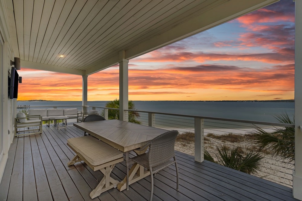 Orange and pink sunset over Santa Rosa Sound seen from the covered deck at Stella Maris on Navarre Beach
