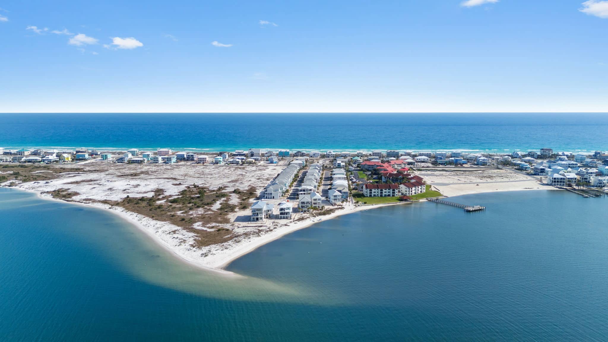 Aerial view of the sugar white sand shoreline and shallow water at Navarre Beach, ideal for beachcombing